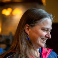 Woman smiles as she enters the stage